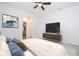 Comfortable bedroom with a TV, ceiling fan, and access to a private bathroom and walk-in closet at 15998 Sw 33Rd Avenue Rd, Ocala, FL 34473