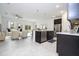 Modern kitchen with an island, stainless steel appliances, dark cabinets, and an open layout at 15998 Sw 33Rd Avenue Rd, Ocala, FL 34473
