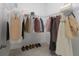 Spacious walk-in closet with clothes hung up on rack and shoes lined along the floor at 15998 Sw 33Rd Avenue Rd, Ocala, FL 34473