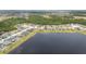 Scenic aerial view showcasing a neighborhood by a large lake, highlighting the community's layout at 1631 Pontiff Pl, Davenport, FL 33896