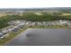 Areal shot capturing a serene lakefront neighborhood amidst lush greenery, offering tranquility and natural beauty at 1631 Pontiff Pl, Davenport, FL 33896