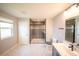 A bright bathroom with a glass-enclosed shower, a window, and a single sink vanity at 1631 Pontiff Pl, Davenport, FL 33896