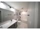 Bright bathroom featuring gray walls, tile floors, and a tub with a subway tile surround at 1631 Pontiff Pl, Davenport, FL 33896