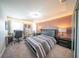 Bedroom showcasing a black leather bed frame, carpeted floor, and natural light at 1631 Pontiff Pl, Davenport, FL 33896