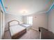 A cozy bedroom with twin beds, soft lighting, and neutral decor at 1631 Pontiff Pl, Davenport, FL 33896