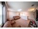 Upstairs bonus room with two couches, media center, and bookcase at 1631 Pontiff Pl, Davenport, FL 33896