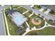 Overhead shot of a community pool, surrounded by lounge chairs and a playground, enhancing outdoor living at 1631 Pontiff Pl, Davenport, FL 33896
