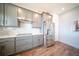 Kitchen featuring gray cabinets, stainless steel refrigerator, and mosaic backsplash at 1631 Pontiff Pl, Davenport, FL 33896
