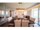 Open-concept living room with large dining table and chairs, modern lighting, and sliding glass doors at 1631 Pontiff Pl, Davenport, FL 33896