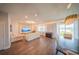 Open-concept living area with hardwood floors, recessed lighting, and large windows at 1631 Pontiff Pl, Davenport, FL 33896