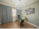 Office featuring modern lighting, desk, and lion artwork at 1631 Pontiff Pl, Davenport, FL 33896