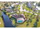 Aerial view showcasing a house with a screened pool and serene waterfront views at 169 Mallard Ln, Daytona Beach, FL 32119