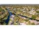 Stunning aerial view of the property featuring a pool, waterfront access, lush greenery and a scenic golf course at 169 Mallard Ln, Daytona Beach, FL 32119