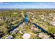 Expansive aerial perspective of the property boasting picturesque waterfront location with verdant landscaping and golf course views at 169 Mallard Ln, Daytona Beach, FL 32119