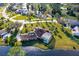 Aerial view of residence with a screened pool, waterway, and manicured lawn at 169 Mallard Ln, Daytona Beach, FL 32119