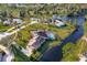 Aerial view of a home with a screened pool, waterway, and beautiful landscaping at 169 Mallard Ln, Daytona Beach, FL 32119
