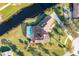 Aerial view outlining a house with screened-in pool, lush landscaping, and waterfront access at 169 Mallard Ln, Daytona Beach, FL 32119
