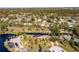 Aerial view featuring a property with a screened pool nestled in a green, waterfront community at 169 Mallard Ln, Daytona Beach, FL 32119