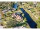 Aerial view of home with screened pool, surrounded by lush greenery and winding waterways at 169 Mallard Ln, Daytona Beach, FL 32119