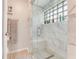 Bright bathroom featuring a glass-enclosed shower with white tile surround at 169 Mallard Ln, Daytona Beach, FL 32119