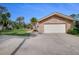 Spacious two-car garage with a driveway and mature trees in front at 169 Mallard Ln, Daytona Beach, FL 32119