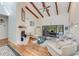 Open living area with vaulted ceilings, exposed beams, and a cozy fireplace at 169 Mallard Ln, Daytona Beach, FL 32119