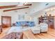 Spacious living room with wood floors, beamed ceilings, and cozy furniture at 169 Mallard Ln, Daytona Beach, FL 32119