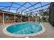 Enclosed swimming pool featuring a screened-in enclosure and a spacious patio at 169 Mallard Ln, Daytona Beach, FL 32119