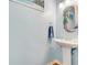 Charming powder room featuring a pedestal sink, hardwood floors, and coastal decor at 169 Mallard Ln, Daytona Beach, FL 32119