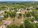 Aerial view displaying a the property's location amidst lush trees, homes, and greenery at 2002 Adair St, Ocoee, FL 34761