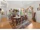 Formal dining room with chandelier, china cabinet, dining table seating six, and large windows at 2002 Adair St, Ocoee, FL 34761