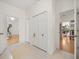 Hallway with tile floor leading to rooms with wood floors and closet with double doors at 2002 Adair St, Ocoee, FL 34761