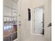 Hallway with tile flooring, leading to bathroom and Gathering room with glass doors at 2002 Adair St, Ocoee, FL 34761