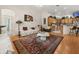 Living room open to the kitchen, featuring plush seating, hardwood floors, and plenty of natural light at 2002 Adair St, Ocoee, FL 34761