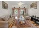 Cozy living room featuring a ceiling fan, natural light, and comfortable seating area with plush furnishings at 2002 Adair St, Ocoee, FL 34761