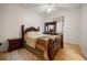 Spacious bedroom featuring a four-poster bed, wood floors, and an area rug at 2002 Adair St, Ocoee, FL 34761