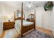 Spacious bedroom featuring a four-poster bed, wood floors, and large windows at 2002 Adair St, Ocoee, FL 34761
