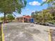 This is a wide shed with an ample parking area and covered patio, offering versatile outdoor living space at 2002 Adair St, Ocoee, FL 34761