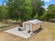 Exterior of the storage shed featuring a metal roof, concrete foundation, and utility access at 2002 Adair St, Ocoee, FL 34761