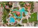 Aerial view of a community pool area featuring a lazy river, water slides, and ample seating at 202 Napoli Dr # 202, Davenport, FL 33897