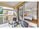 A cozy balcony view showing the bedroom inside with a ceiling fan and access to natural light at 202 Napoli Dr # 202, Davenport, FL 33897