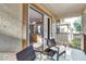 Tranquil balcony seating area, offering a sneak peek into the bedroom's dresser and decor at 202 Napoli Dr # 202, Davenport, FL 33897