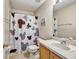 Well-appointed bathroom featuring a vanity, toilet, and shower with a charming Mickey Mouse shower curtain at 202 Napoli Dr # 202, Davenport, FL 33897