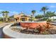 Regal Palms clubhouse entrance featuring a fountain, tropical landscaping, and clear blue skies at 202 Napoli Dr # 202, Davenport, FL 33897