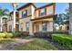 Attractive two-story townhome with lush landscaping and a welcoming entrance at 202 Napoli Dr # 202, Davenport, FL 33897
