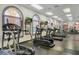 Well-equipped gym with treadmills, elliptical machines, and large arched windows at 202 Napoli Dr # 202, Davenport, FL 33897
