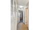 Bright hallway featuring neutral paint, carpet flooring, and white doors including closet and bedroom access at 202 Napoli Dr # 202, Davenport, FL 33897