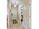 Inviting hallway with tile flooring, neutral walls, and a glimpse into the living space at 202 Napoli Dr # 202, Davenport, FL 33897