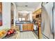 Kitchen featuring stainless steel appliances, oak cabinets, and a view into the adjacent dining area at 202 Napoli Dr # 202, Davenport, FL 33897