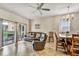 Open-concept living area with tile floors, a leather sofa, dining table, and access to the patio at 202 Napoli Dr # 202, Davenport, FL 33897
